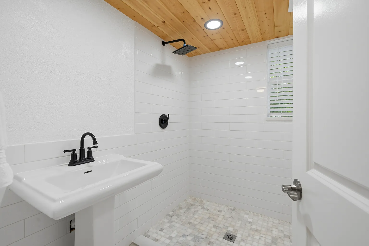 Updated shower with wood ceiling detail