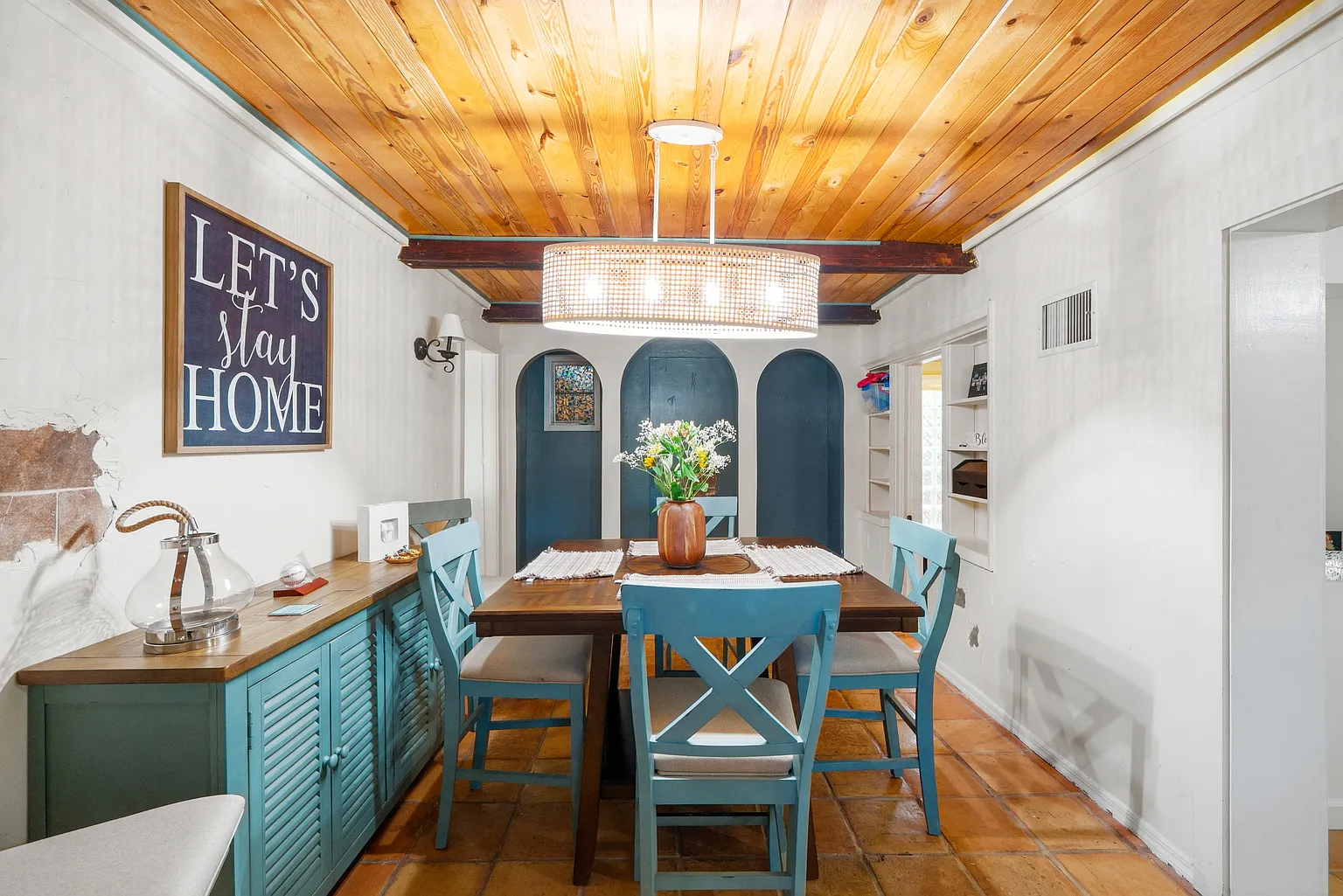Dining room with arched details and wood ceiling