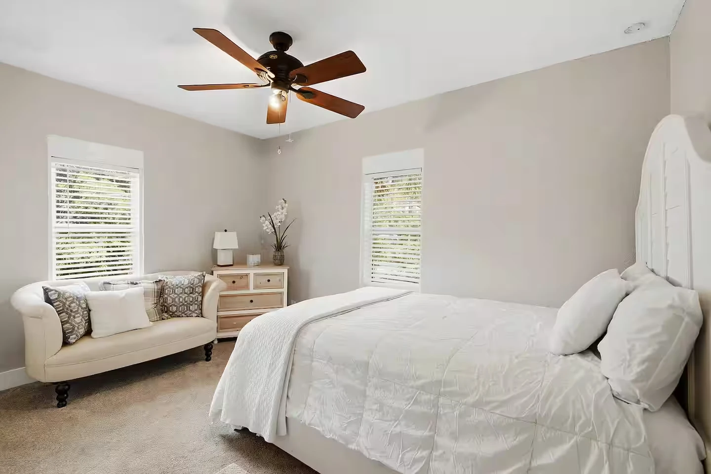 Bright upstairs bedroom with two windows and sitting area