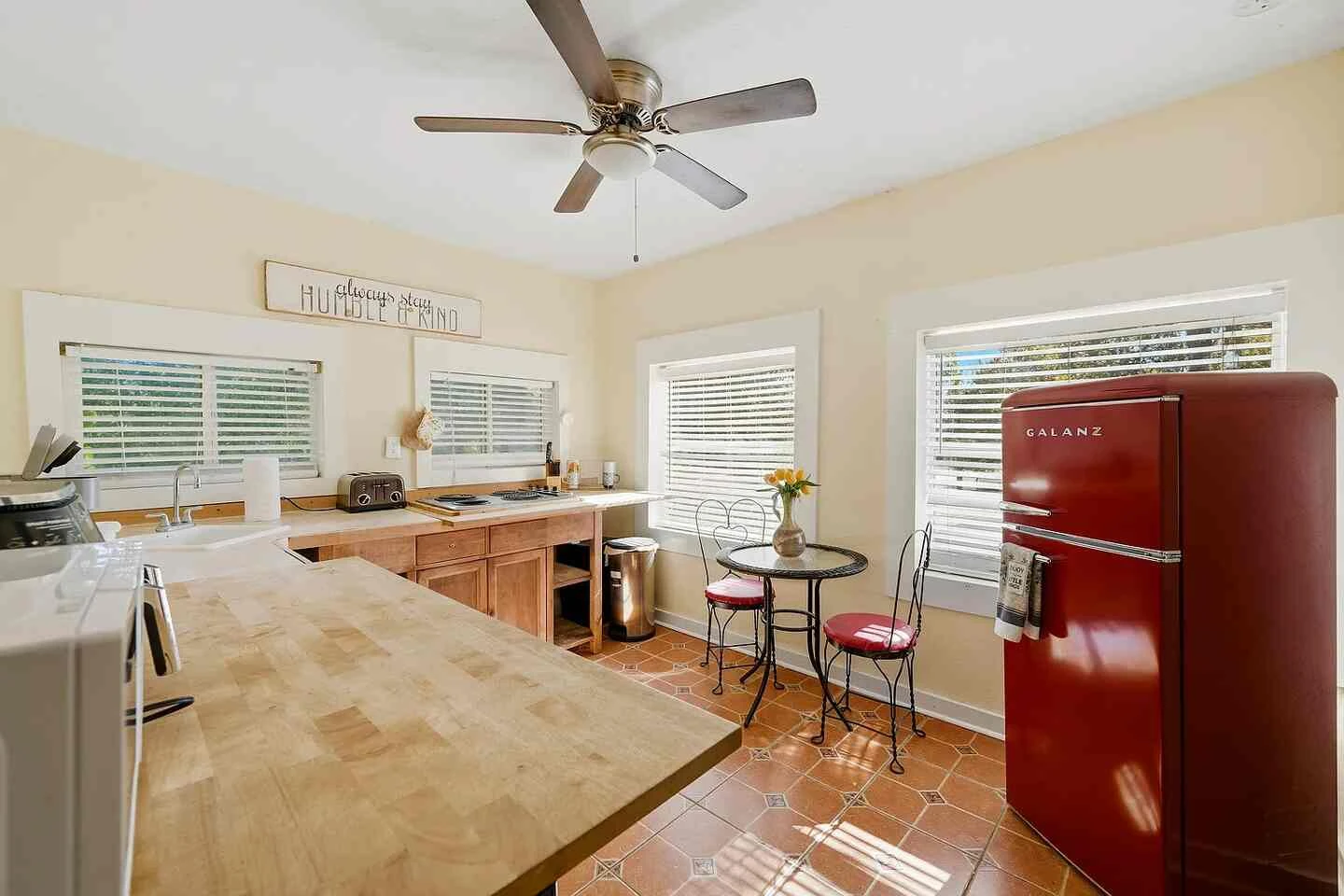 Upstairs kitchen with butcher-block counters and vintage-style red refrigerator